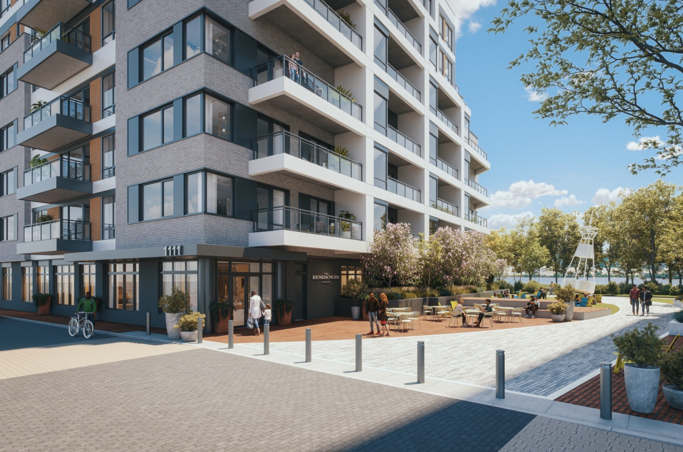 Street-level view of residential entrance with outdoor seating and blooming landscaping