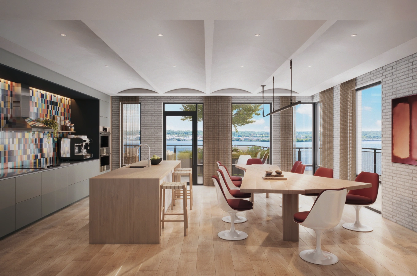 Spacious dining and kitchen area with large windows offering riverfront views