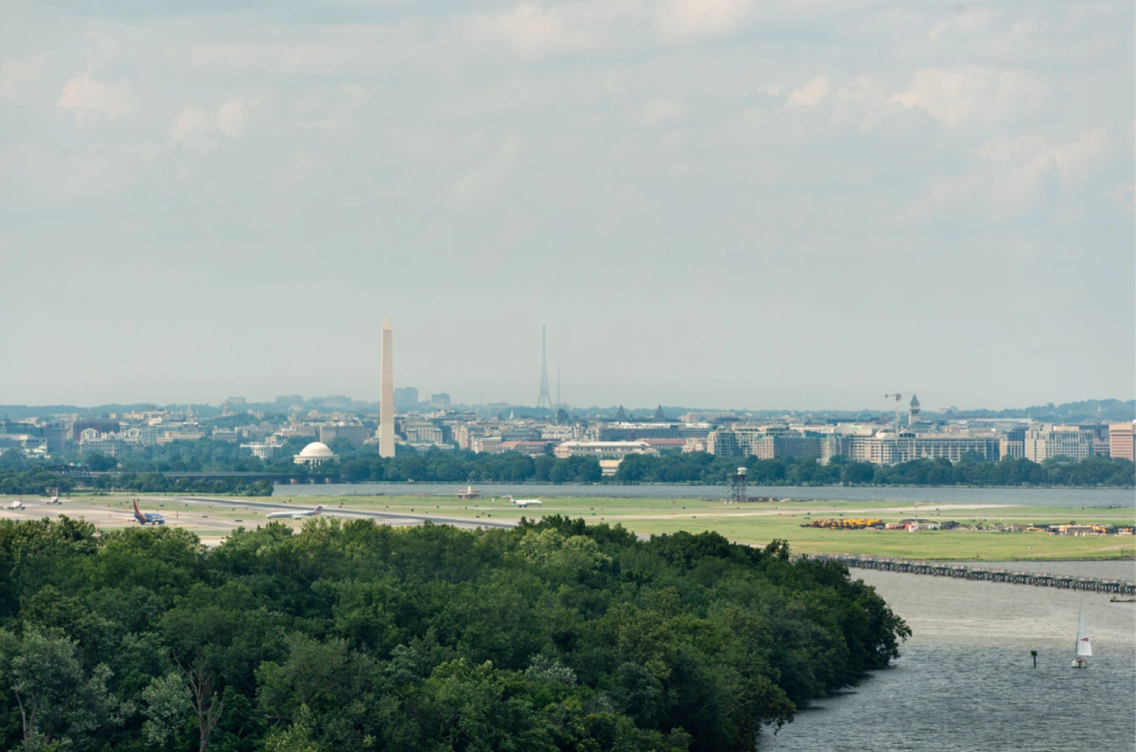 Panoramic shot of DC skyline showing Washington Monument and Jefferson Memorial across airport
